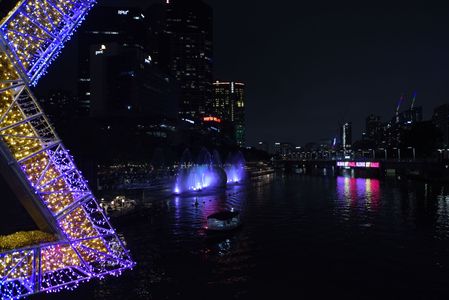 Australian people enjoying lighting show in connection with the upcoming Christmas Celebration at Yara River in Melbourne.