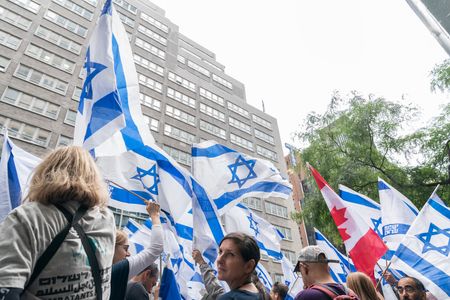 Hundreds of activists rally against judicial reforms proposed by the government in front of Israeli mission to the UN on 2nd Avenue in New York as Prime Minister Benjamin Netanyahu visit. Rally was held after Prime Minister delivered speech during United Nations General Assembly 78th Session. Israeli flag on top of the mission seen through protesters.