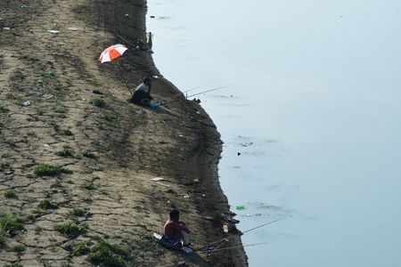 Kashmiris fishing in the dried portion of the Jhelum river in Srinagar, Indian controlled Kashmir, Wednesday, 13 September 2023. The water level in the River Jhelum has recorded a significant drop due to deficit rainfall in Kashmir. The local Meteorological Department has forecasted dry and hot weather till next few weeks of September and there is no possibility of rainfall in the region.