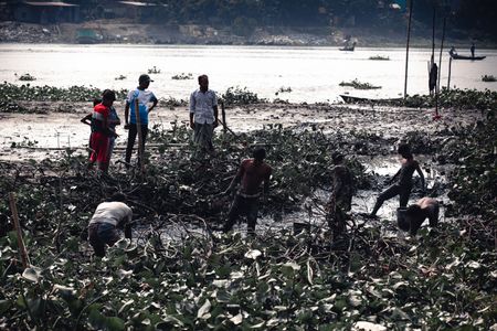 In the heart of Keraniganj, November 2023 unveils the magic of seasonal change along the Burigonga River. "Beneath the Surface" captures the community's ancient practice of hand fishing as the waters recede, revealing a hidden world beneath. Against the autumnal palette, each photograph narrates a story of resilience and harmony with nature. This visual journey is a testament to Keraniganj's adaptability and the timeless dance between its people and the river.