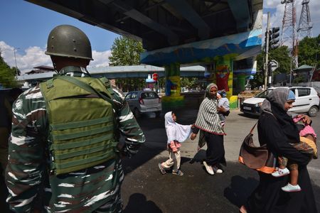 Paramilitary soldiers stand guard and taking pictures a vehicle during frisking at Lal Chowk area on May 05, 2023 ahead of G20 Summit in Srinagar the Summer captial of Indian Administrated Kashmir.