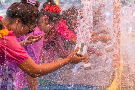Celebration of Sangrai Festival or Water festival, one of the biggest festivals of the Rakhaine & Marma community organized to celebrate New Year. A week long program, “Sangrai Powey” in Rakhaine means 'new year'. It is held in April 13-19. One of the days falls in Pohela Boishakh.
Pani Khela or Jolkali is the main attraction of the festival. Young Rakhain men and women wearing traditional dress playfully douse each other with water with the music of local song. It is believed that this tradition removes the woes, pain and sins of the previous year and people are reinvigorated to have a good start.
It is done with the participation of boys and girls who are still single. They are positioned in the two sides of a tables or arena wherein basins of water are at their front and they splash the water against each other. It is believed that water splashing is a means of expressing feelings of love.