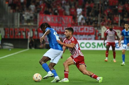Masouras no 19 of Olympiacos is pressing Kayembe no 18 of Genk.