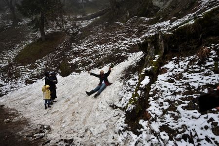 Tourists enjoying at Gulmarg after a unseasonal fresh spell of snow on May 08, 2023 in Gulmarg, Indian Administrated Kashmir. Unseasonal snowfall in parts of Kashmir brought back the winter-like conditions in the Valley while several incidents of tourists and nomadic people getting stuck due to inclement weather were also reported, Gulmarg, Pahalgam, Sonamarg and Qazigund areas of the Valley received snowfall early in the morning, making the roads slippery.
