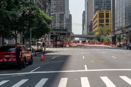 Emergency Services respond to a construction crane collapse after engine fire damaged cables in midtown Manhattan, New York