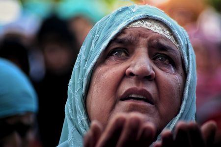 A Kashmiri Muslim prays as a head priest displays a relic, believed to be a hair from the beard of the Prophet Mohammad, at the Hazratbal shrine on Eid-e-Milad, the birth anniversary of the prophet in Srinagar, Indian controlled Kashmir.