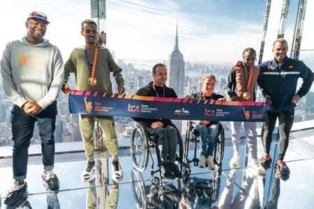 (L-R) Race Director Ted Metellus, 2023 TCS (Tata Consultancy Services) New York City Marathon champions Tamirat Tola of Ethiopia, Marcel Hug of Switzerland, Catherine Debrunner of Switzerland, Helen Obiri of Kenya, New York Road Runners CEO Rob Simmelkjaer seen visiting SUMMIT One Vanderbuilt observation deck.