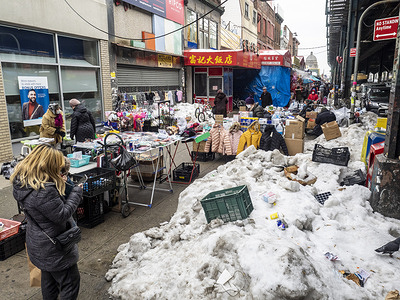 Street vendors, some of them illegal, overtaking streets of Bensonhurst trying to survive during pandemic time. Folding tables, closing racks, boxes with merchandise blocking pedestrians from walking freely on the street.