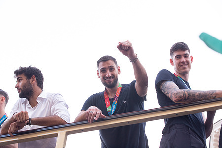 Gianluigi Donnarumma, player of Italian National Football Team celebrate victory of European Football Championship by showing the cup on an open bus through the streets of Rome with fans following them and singing choirs