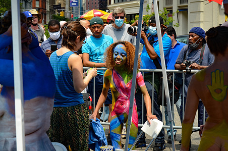 A young Participant is being paintedduring the annual bodypainting day in New York City, July 25, 2021.
