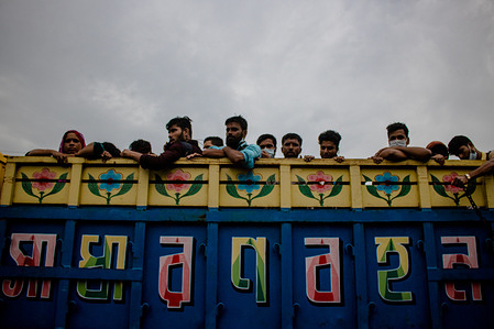 Garment workers on their way back to Dhaka by truck after they were ordered by the garment authorities to join work starting 1st of August.
As all the public transportations are closed, people are seen to use Trucks, Covered van, Rickshaw even some have walked all the way to Dhaka during this pandemic situation.