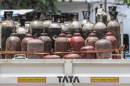A transport vehicle carrying oxygen tanks is seen parked on a road in Colombo, as the country is in total lockdown due to the spread of COVID-19.