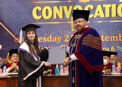Vice chancellor of Mehran university of Engineering and Technology giving away graduation degree among the passing out students during the 24th convocation