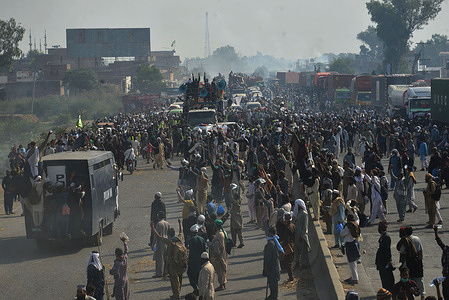 Pakistani supporters of Tehreek-e-Labbaik Pakistan (TLP) party take part in a protest march towards capital Islamabad from Lahore, demanding the release of their leader Hafiz Saad Hussain Rizvi, son of late Khadim Hussain Rizvi, founder of hardline religious political party Tehreek-e-Labbaik Pakistan. Thousands of supporters of the banned radical Islamist party departed Lahore on oct,24,2021.clashing for a fourth straight day with police who lobbed tear gas into the crowd, a party spokesman and witnesses said.