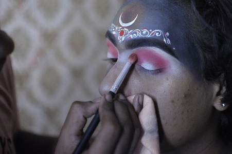 A male celebraty transform himself to Hindu Goddess Kali in a studio, for a Bengali Cinema at South kolkata.Makeup artist Anupam R painting on him.