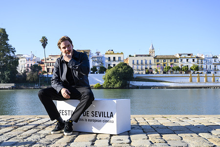 Daniel Brühl poses during a photocall in the Seville Film Festival a side the Gualdalquivir river in November 12th, 2021.