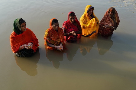 Women are taking their Holy bath and praying God Sun during this Chhath festival at Kolkata.