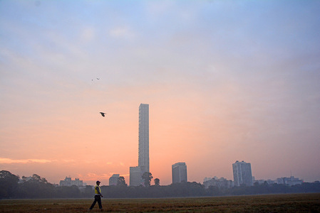People come to the grounds for exercise in the morning. Today it was foggy. It was feeling cold at 5;30 AM. In the background of the picture, the name of the building was The 42. Construction of the building was topped off in 2019, making it the tallest building in the country at that time.