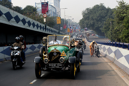 Owner of a1916 German made Stoewer car driveduring a vintage car show in Kolkata
