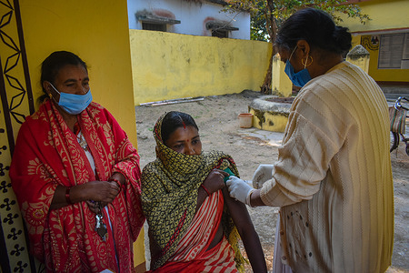 A woman receives a dose of COVISHIELD, a vaccine against the coronavirus disease (COVID-19) at a health centre on an outskirt area in Simultala, Bihar.