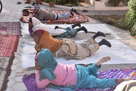 People of home for the aged do yoga on the chilled winter morning in Bikaner.