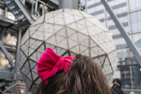 Preparation of New Yearâ€™s Eve Ball by installation of panels with new Waterford crystals named Gift of Wisdom on top of One Times Square. A woman's red hairdo seen in front of preparing Ball.