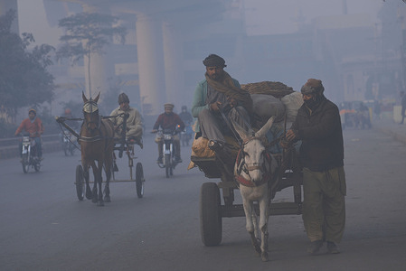 Pakistani citizens busy in their routine work during a cold and dense foggy morning in Lahore. Pakistani residents and commuters are more worried than surprised due to the sudden layer of dense smog which is causing problems in respiration, visibility and has also hampered smooth flow of traffic, residents of Lahore woke up to a dense blanket of smog on Thursday that reduced visibility for commuters and prompted several complaints of respiratory problems and mental anguish.