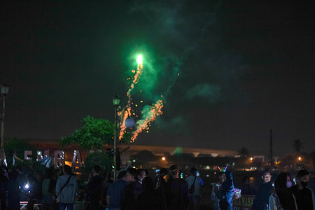 A group of people are watching fireworks in the courtyard of Kuto Besak Fort.