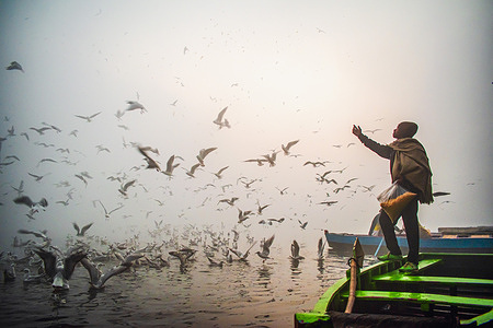 A man arrives early in the morning on the bank of Yamuna River to see the migratory seagulls which come from Siberia in winter amid dense fog as Delhi plunged to minimum temperatures of 4 degrees Celsius on the first day of New Year.