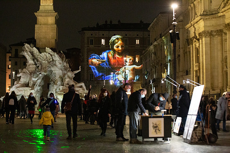 Detail of artistic projections, depicting pictorial masterpieces of Renaissance, in Piazza Navona in Rome