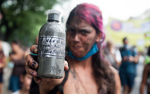 A protester holding an oil container during theprotest against the oil exploration project off the Atlantic coasts by the Norwegian oil company Equinor.