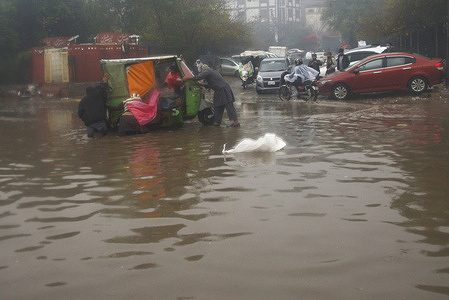 Pakistani people face difficulties after heavy first spell winter rain falls in Lahore.