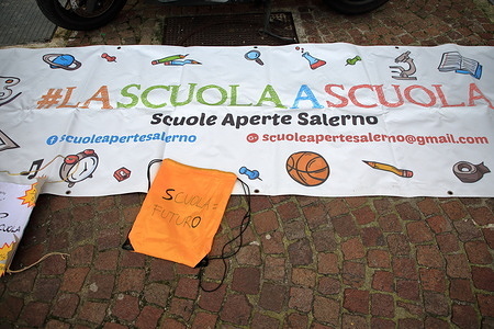 Salerno, Italy : January 09,2022 : Parents and teachers protest in Piazza Giovanni Amendola against the order of the President of the Campania Region , Vincenzo De Luca , which imposed the non reopening of schools from 10 January , due to the increasing number of infections from covid-19. Imposing for elementary and middle schools the DAD (Distance Teaching) at least until the end of January.