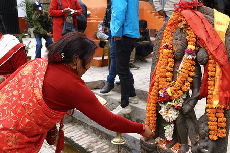 women worship the historical statue of god "Padmapani Lokeshwor" after itsrestoration in Kathmandu, Nepal