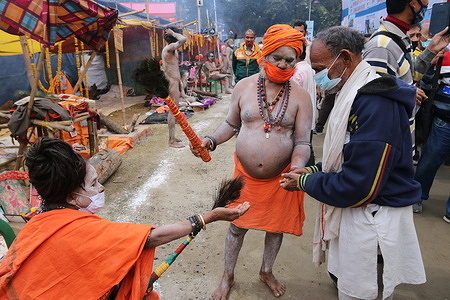 Sadhublesses a devotee at a transit camp on way to Gangasagar in Kolkata. Deployment of doctors at Gangasagar Mela has become a major challenge for the South 24-Parganas district administration barely a day ahead of commencement of the grand fair with around 100 doctors of Diamond Harbour Government Medical College and Hospital having tested positive for Covid-19.With many of the remaining doctors having been assigned duties at the Mela, the hospital authorities have appealed to the district administration for exemption of their duties, else, it would become difficult to render regular patient services at the hospital..