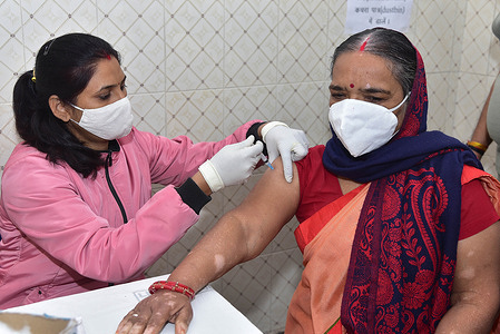A health worker administers booster dose of COVID-19 vaccine to an elderly woman at a Government Hospital. Vaccination Drive for the third dose or precautionary dose to priority groups - Health care workers, frontline workers, and those aged above 60 years with comorbidities began.