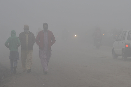 Pakistani citizens on their way at Band Road through thick blanket of fog in Lahore. Pakistani residents and commuters are more worried than surprised due to the layer of dense fog which is causing problems in respiration, visibility and has also hampered smooth flow of traffic, residents of Lahore woke up to a dense blanket of Fog on Thursday that reduced visibility for commuters and prompted several complaints of respiratory problems and mental anguish.