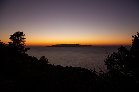 View of sunset on Giglio island from Monte Argentario