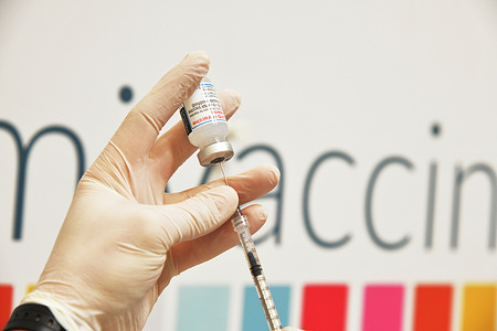A doctor prepares a booster dose of Moderna Covid-19 vaccine to patients in a vaccination hub. Today there are 180,426 positive positive cases of covid-19 and 308 death.