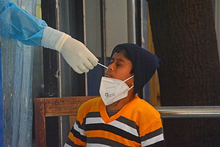 Health worker collecting swab from this boy. Covid test was done in a hospital during the surge of covid omicron variant, children are also infected. India logged 2.58 lakh Covid-19 cases and 385 deaths in the last 24 hours according to the health report updated on Monday.
