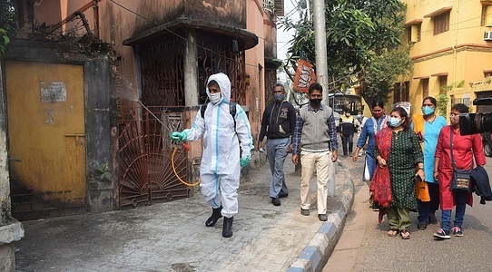 Kolkata corporation worker wearing PPE sanitizes the street amid Coronavirus Emergency in Kolkata.