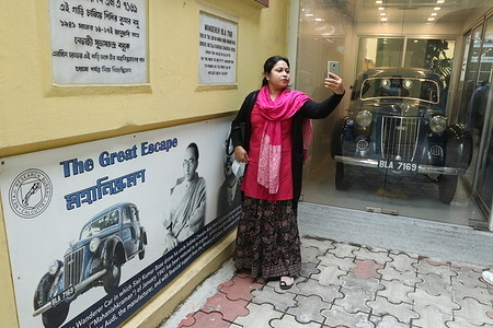 A woman take selfie in front of the Historic Wandere Car at Netaji Subash Chandra Bose House in Kolkata