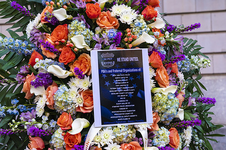 Flowers seen outside of 32nd precinct. Tributes poured in for police officer Jason Rivera who was killed in the line of duty. Officers from Westchester counties arrive to 32nd precinct and laid flowers. Police Officer Jason Rivera was killed by gunman on January 21, 2022 while responding to a domestic dispute call.