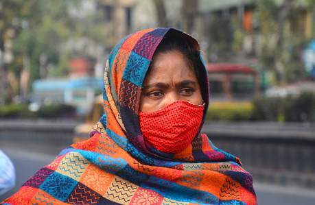 A woman wearing face mask to protect herself from covid-19. Everyday the number of (Covid-19) Omicron cases are increasing rapidly all over the world.