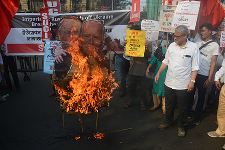 Leftist activists of Socialist Unity Center of India (SUCI) party members protest and burn effigies of Russian president Vladimir Putin and US president Joe Biden embracing as they protest against the Russian invasion in Ukraine during a rally in Kolkata.