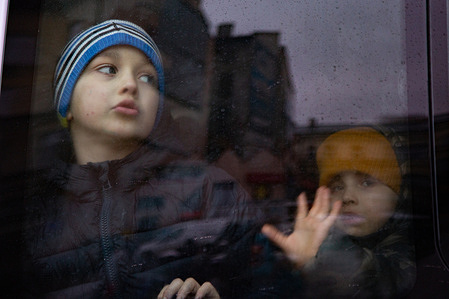 A boy looks out of the train window as it leaves for Krakow.