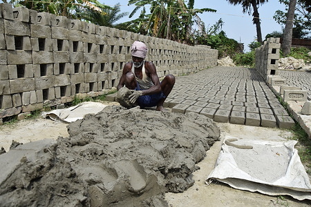 The daily life of a worker at a sun-dried brickfield besides the Ganges, which does not have firing unit.