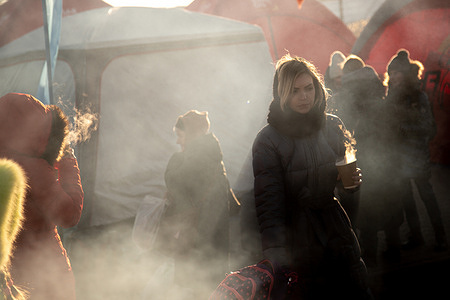 Ukrainian refugees warm up with coffee at the border in Medyka, Poland.