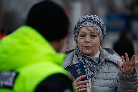 An elderly woman holding her passport ready to cross the border. Hundreds of Ukrainians fled their homes and cross the border into Moldova in the city of Palanca. Nearly three million people have fled Ukraine into neighboring countries since Russia launched a large-scale invasion of the country on February 24.