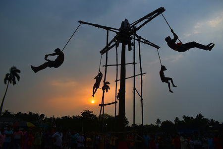 Hindu devotees hang on ropes performs during "Chadak" ritual, which is held to worship the Hindu deity Lord Shiva, on the outskirts of Kolkata.